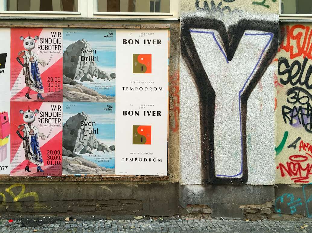 wheatpasted posters on wall
