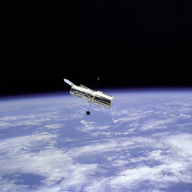 Flyaround of the Hubble Space Telescope after deployment on this second servicing mission (HST SM-02). Note the telescope's open aperture door, (1997) (NASA)