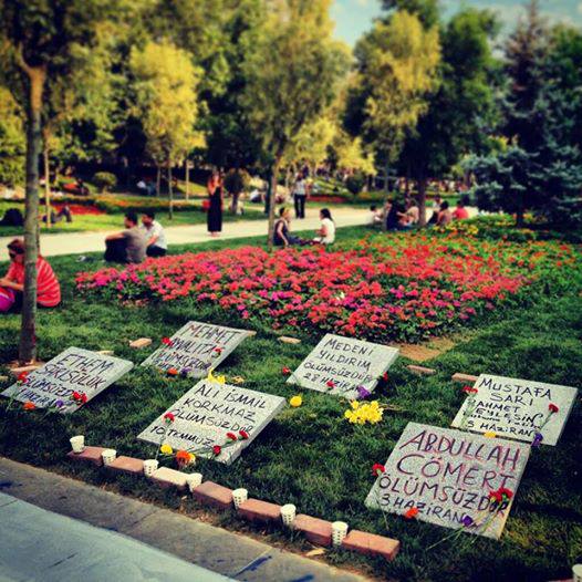 Gravestones in Gezi Park in memory of Medeni Yıldırım, Ali İsmail Korkmaz, Mehmet Ayvalıtaş, Abdullah Cömert, Ethem Sarısülük and police officer Mustafa Sarı. Found image.