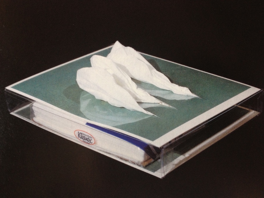 General Idea, Gesundheit: Why Not Sneeze Lucio Fontana? (1991). Two found post cards, one cut, Kleenex-brand packaged tissue, in plastic box, 4.3 x 5.9 x .78 inches. Photo: Blackwood Gallery
