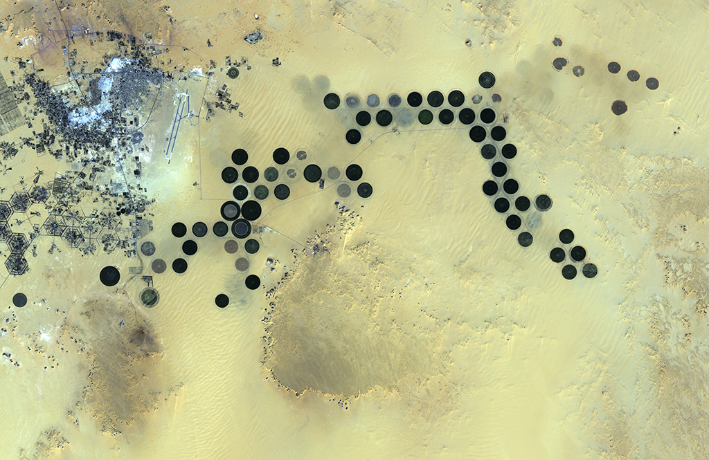 Circular irrigated agricultural plots near the the Al Jawf oasis in Libya, as seen from Japan's ALOS satellite. Image: European Space Agency